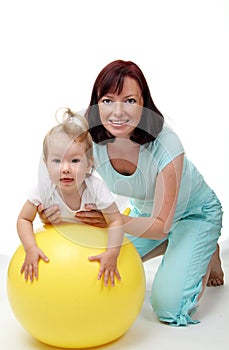 Mother hold daughter on Fitness Ball