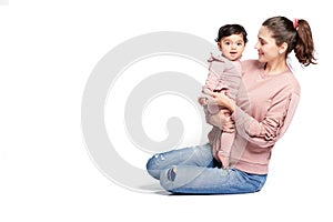 Mother holding baby daughter isolated on white.