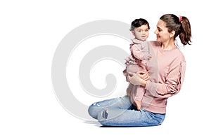 Mother holding baby daughter isolated on white.