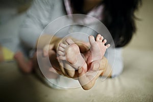 Mother holding baby feet in hand