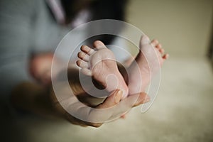 Mother holding baby feet in hand