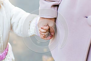 Mother holding baby hand