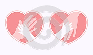 Mother holding baby hand in heart shaped symbol