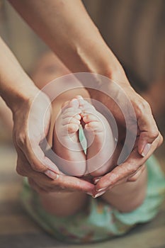 Mother holding baby's feet