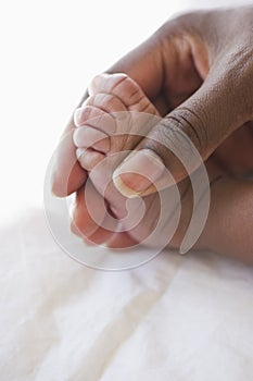 Mother holding baby's foot