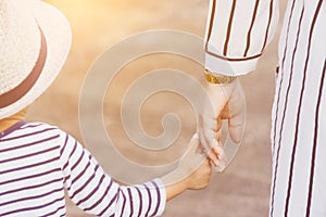 Mother holding a child`s hand