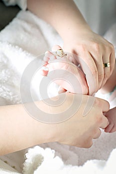 Mother holding child's little foot