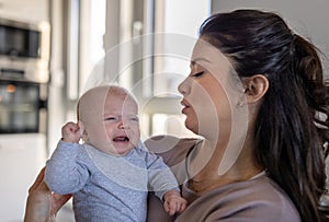 Mother holding crying baby