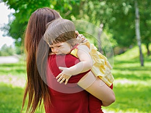 Mother holding crying baby girl with tears