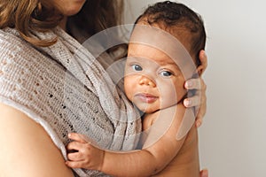 Mother holding cute newborn smiling child