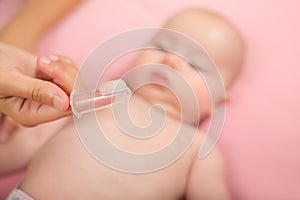 Mother holding fingertip brush for children