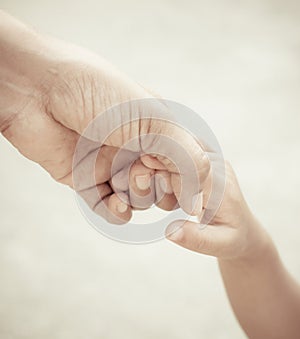 Mother holding a hand of child