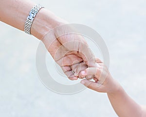 Mother holding a hand of child