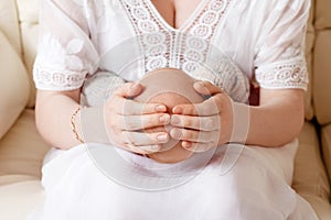 Mother holding head of her newborn son in hands. The baby on hands at mum. Loving mother hand holding cute sleeping newborn baby