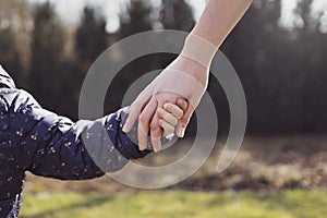 Mother holding her daughter hand