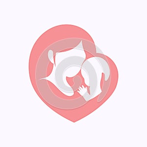 Mother holding her little baby in heart shaped silhouette