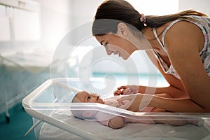 Mother holding her newborn baby child after labor in a hospital