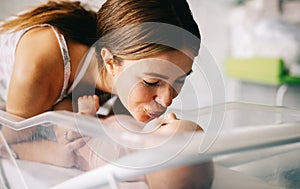 Mother holding her newborn baby child after labor in a hospital