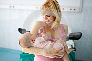 Mother holding her newborn baby child after labor in a hospital