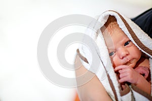 Mother holding her newborn baby daughter after birth on arms.