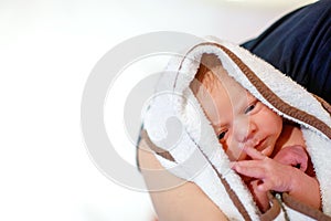 Mother holding her newborn baby daughter after birth on arms.