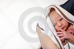 Mother holding her newborn baby daughter after birth on arms.