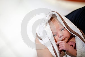 Mother holding her newborn baby daughter after birth on arms.