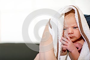 Mother holding her newborn baby daughter after birth on arms.