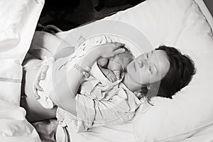 Mother holding her newborn baby after labor in a hospital.