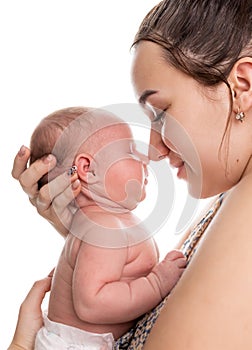 Mother holding her newborn baby on a white background. Baby care.