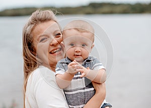 Mother holding and kissing son