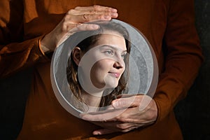 Mother Holding A Mirror And Reflexion of Daughter