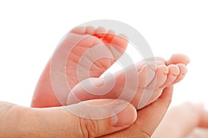 Mother holding newborn baby feet