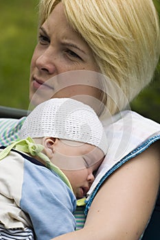 Mother holding sleeping baby