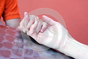 Mother holding Sons Hand Close Up