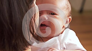 Mother holding and soothing crying baby girl