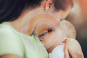 Mother holding to her asleep little son