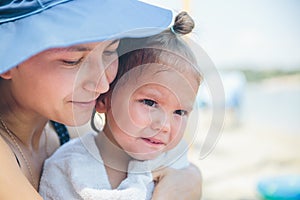 Mother holds daughter on hand while she is crying