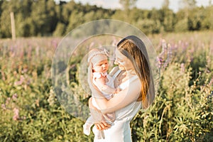 Mother holds her child in her arms, nature, calm atmosphere