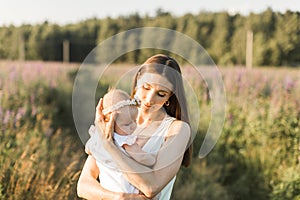 Mother holds her child in her arms, nature, calm atmosphere