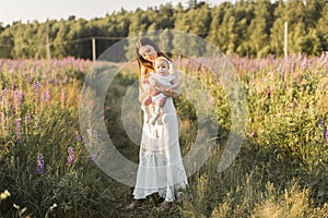 Mother holds her child in her arms, nature, calm atmosphere