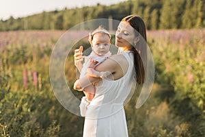 Mother holds her child in her arms, nature, calm atmosphere