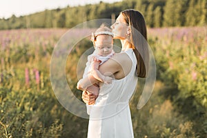 Mother holds her child in her arms, nature, calm atmosphere