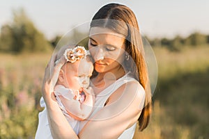 Mother holds her child in her arms, nature, calm atmosphere