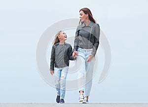 Mother holds her daughter`s hand tightly