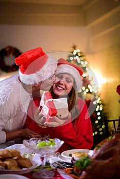 Mother hug and kiss her teenage daughter happily at Christmas celebrations and family dinners photo