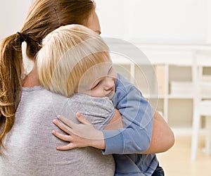 Mother hugging and comforting her son