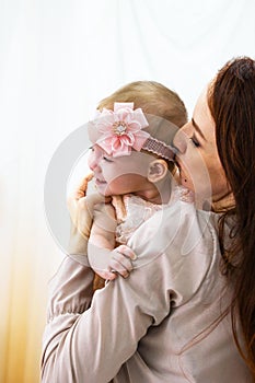 Mother is hugging her little daughter. Maternal hugs. Concept of mother care