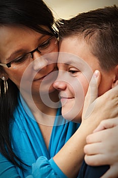 Mother hugging young son