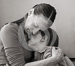 Mother hugs crying son